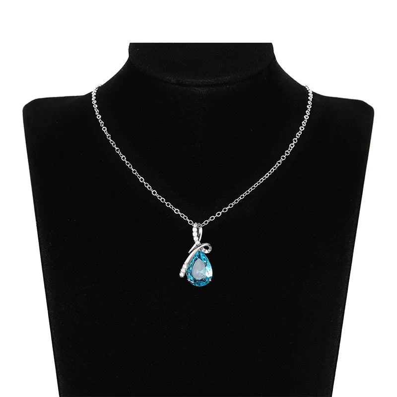 Necklace with a blue teardrop pendant on a black mannequin