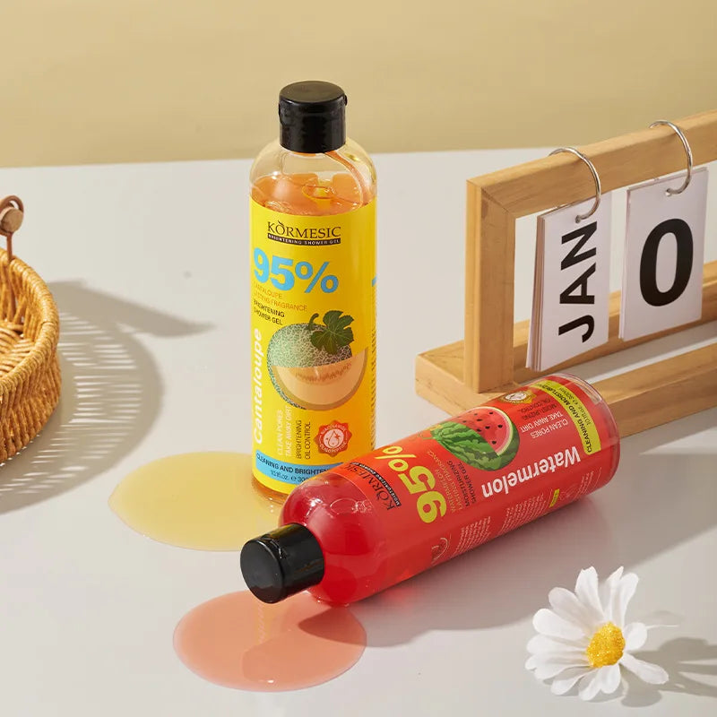 Two bottles of Kormesic 95% spray on a light surface with a calendar and flower in the background.