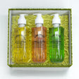 Three bottles of body wash in a decorative box with green and white accents.