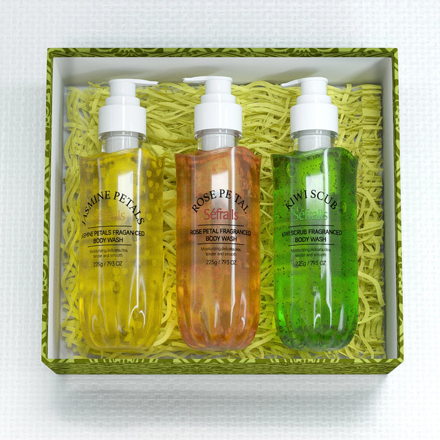 Three bottles of body wash in a decorative box with green and white accents.