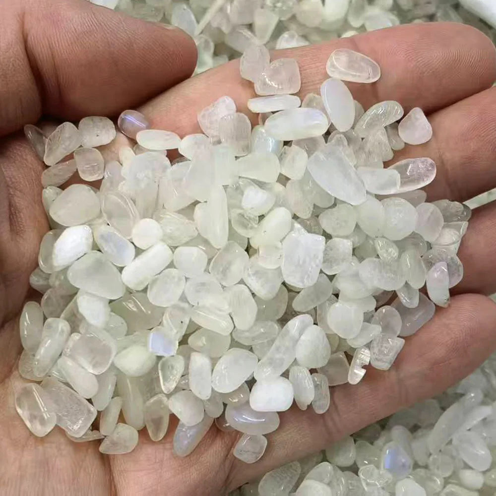 Hand holding a small pile of translucent white stones