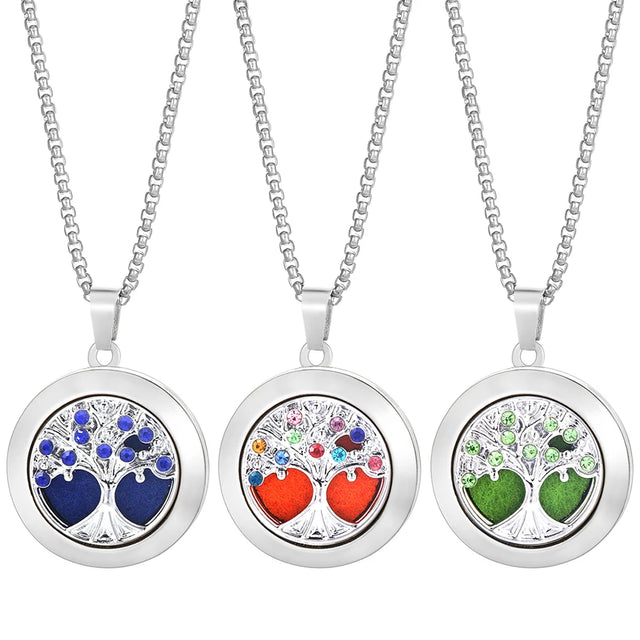 Three tree-shaped locket necklaces with colorful heart designs on a white background