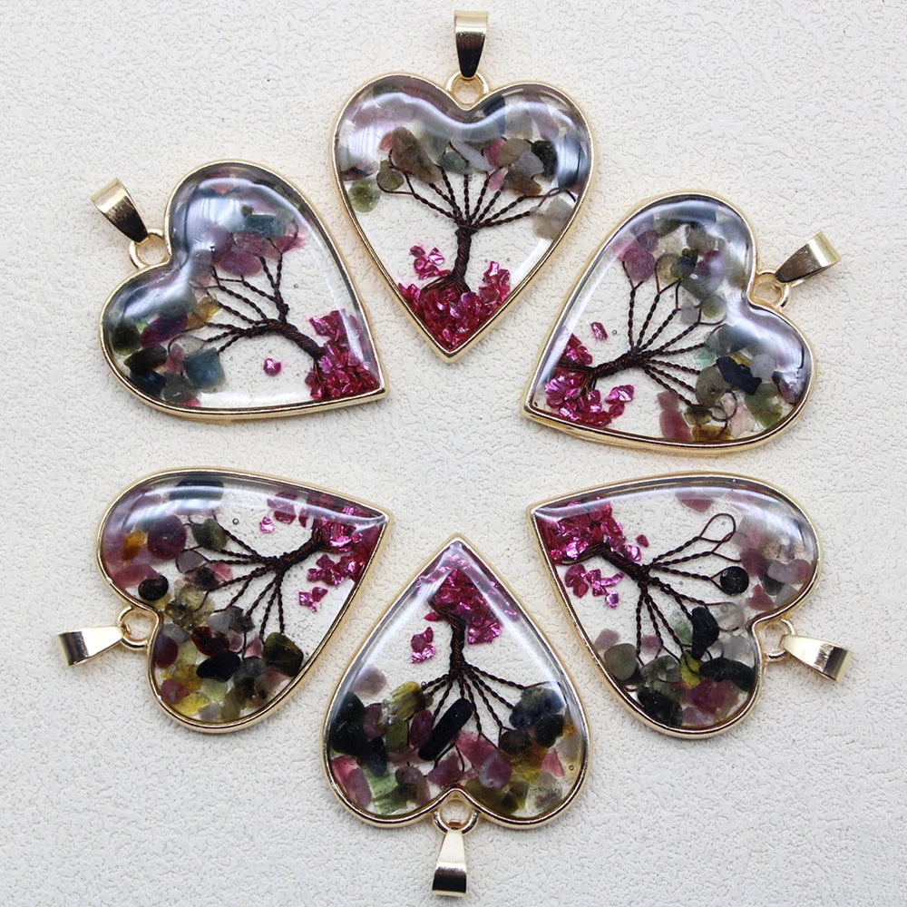 Set of heart-shaped pendants with floral designs on a light gray background