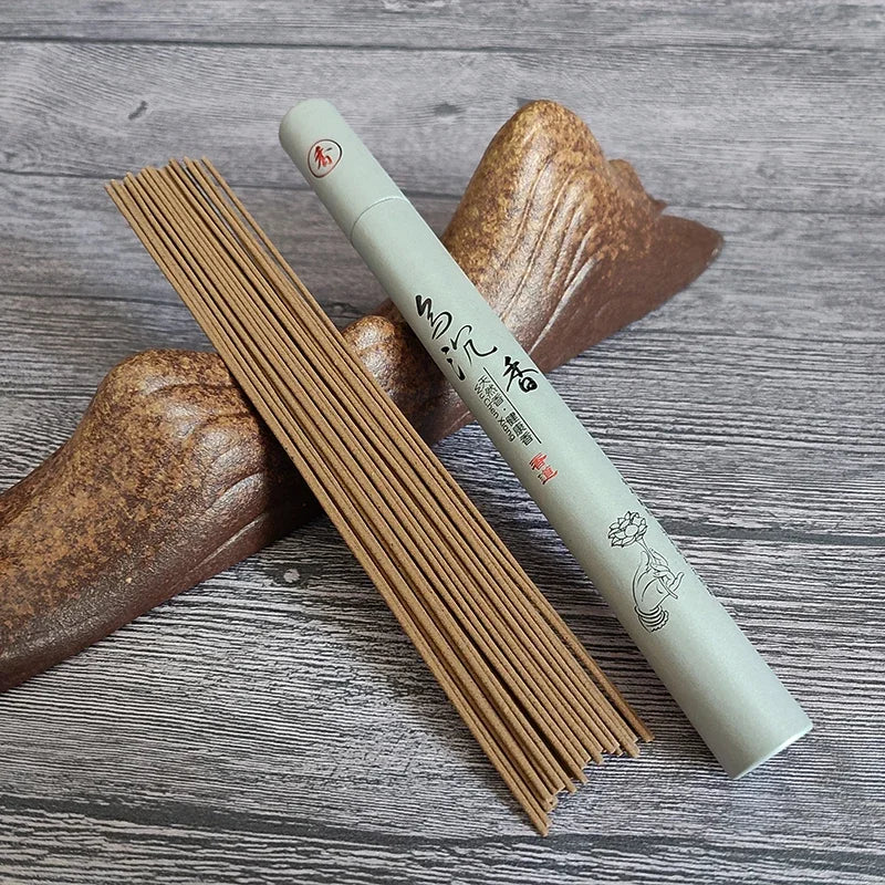 Incense stick and its packaging on a wooden surface