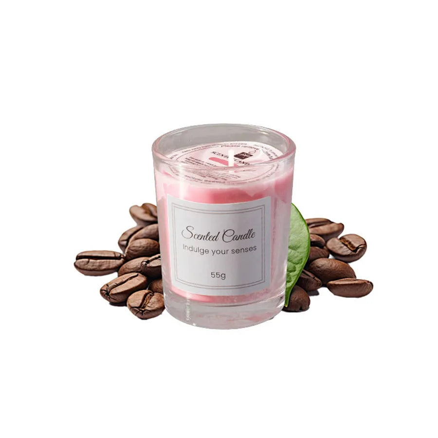 Scented candle with coffee beans and a leaf on a white background