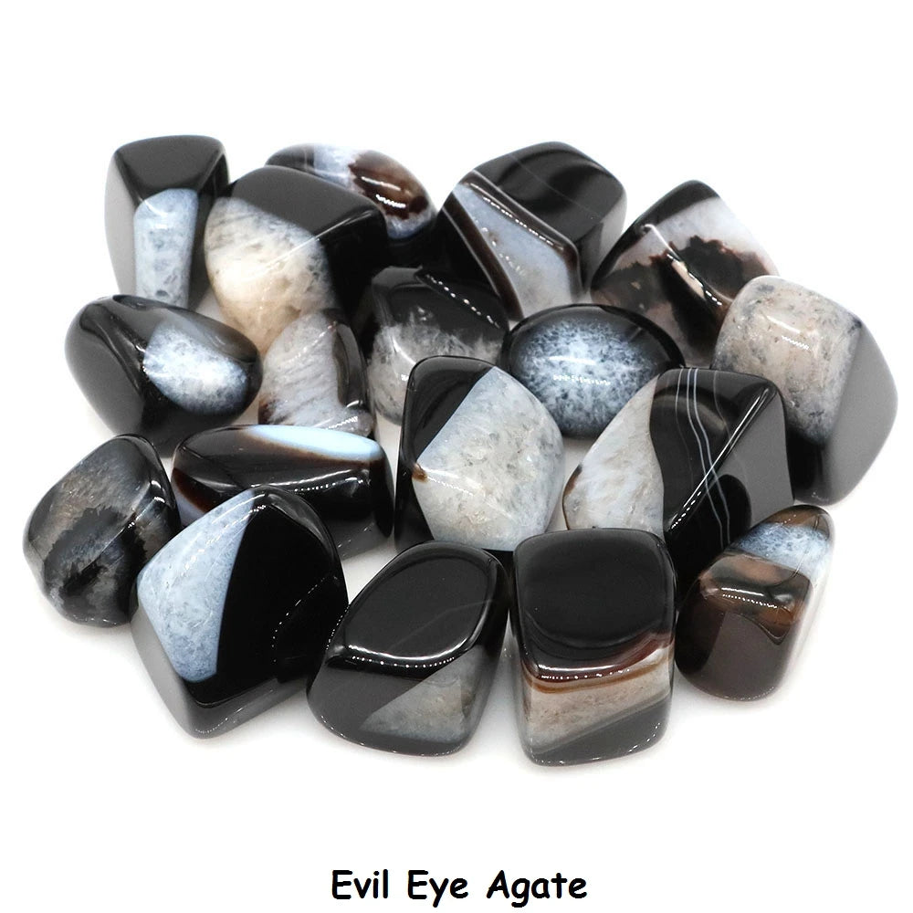 Collection of black and white agate stones labeled 'Evil Eye Agate' on a white background