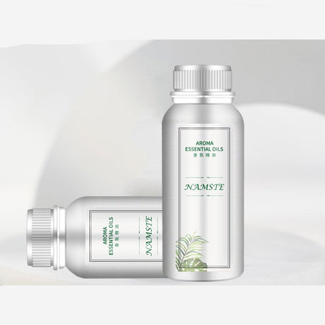 Two NAMSTE essential oil bottles on a light gray background with promotional text.