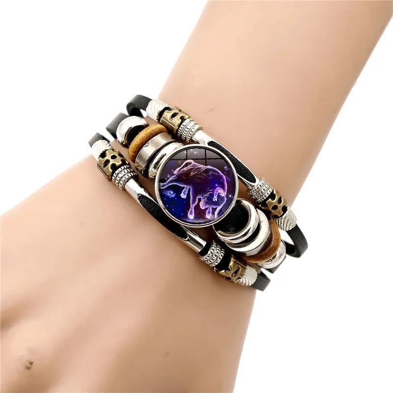 Multistrand bracelet with a purple wolf emblem on a wrist against a white background