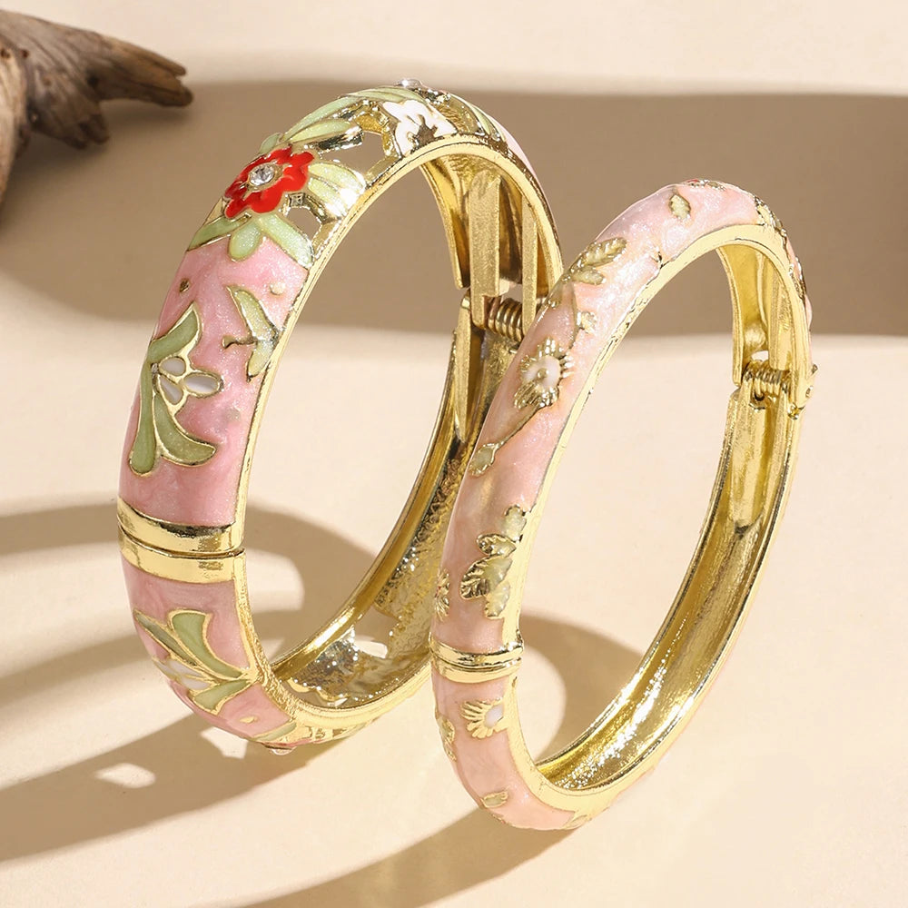 Two decorative bangles with floral designs on a beige background