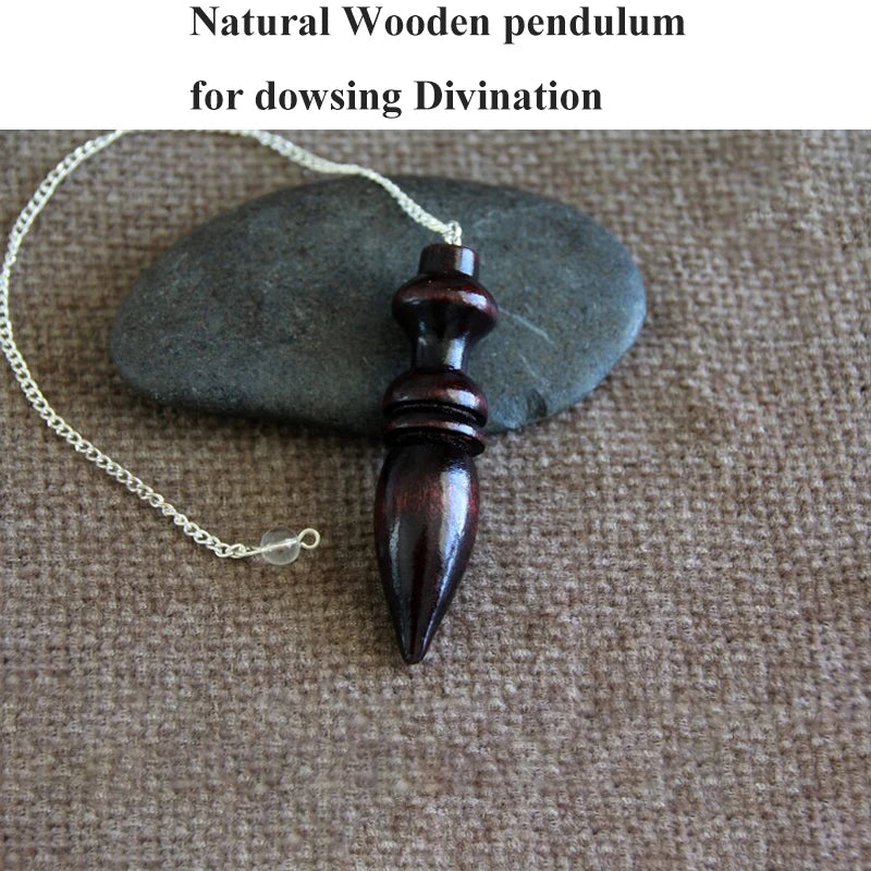 Wooden pendulum for dowsing divination on a stone surface
