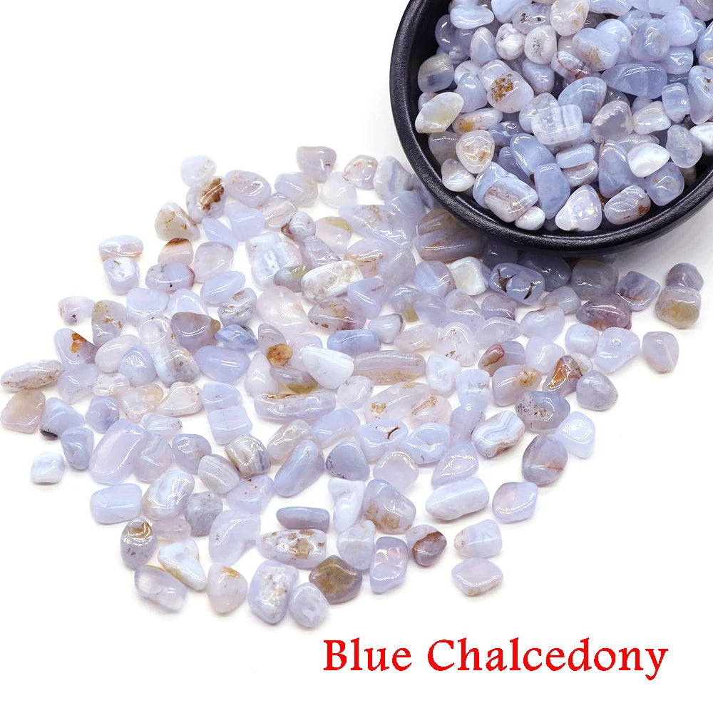 Blue chalcedony stones with a bowl of stones on a white background