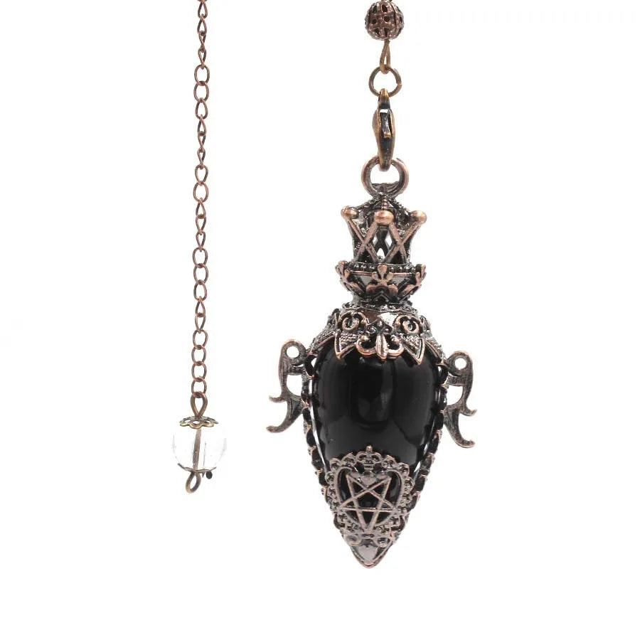 Decorative pendant with black stone and intricate designs on a white background