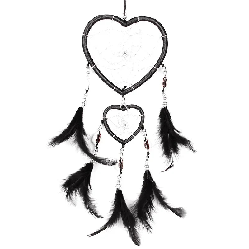 Heart-shaped dreamcatcher with feathers on a white background