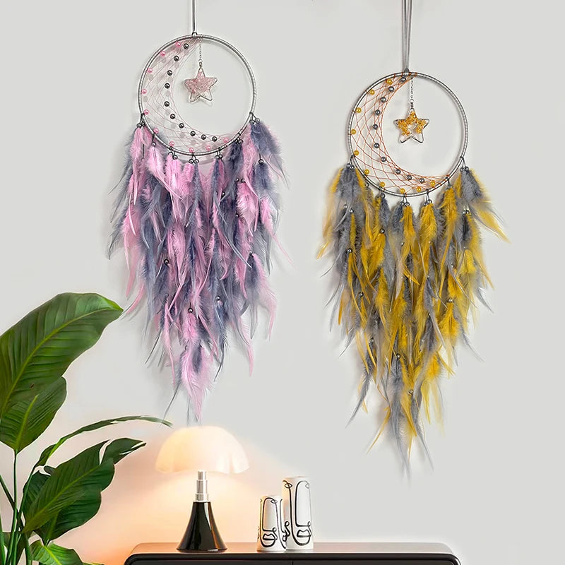 Two dreamcatchers with feathers on a light gray background