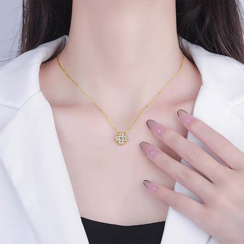 Gold necklace with a heart-shaped pendant worn by a person