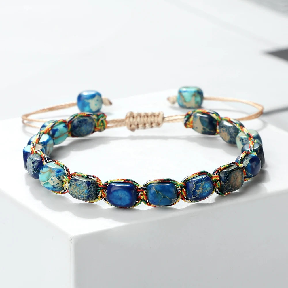 Beaded bracelet with blue and gold stones on a white background