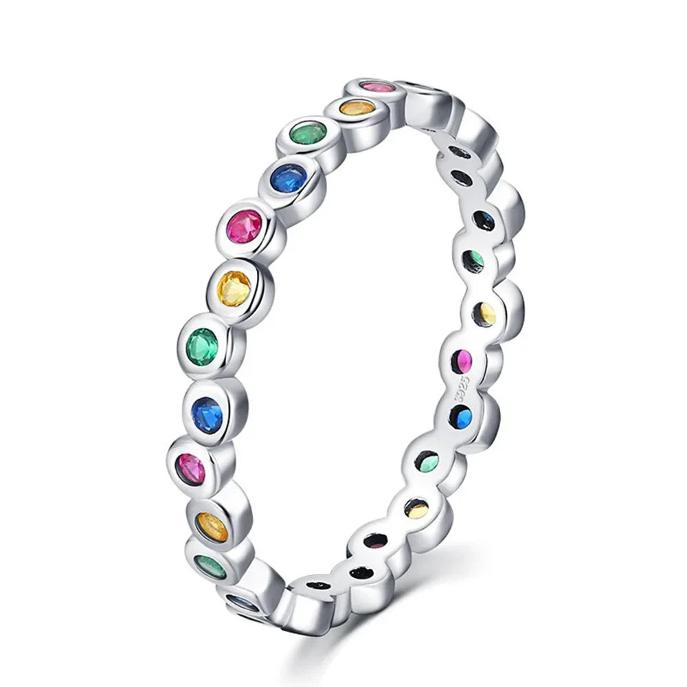 Silver ring with colorful gemstones on a white background