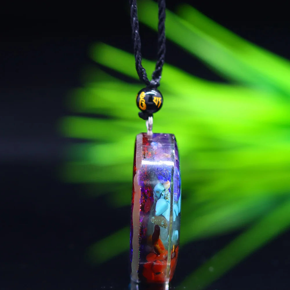 Necklace with a colorful pendant against a blurred green background