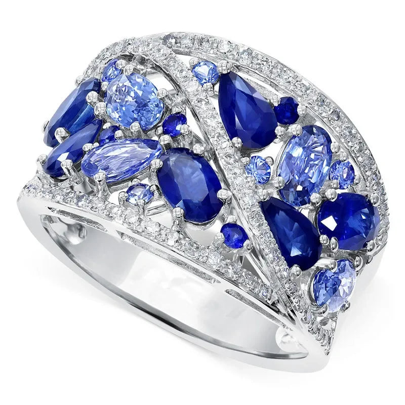 Ring with blue gemstones and diamond accents on a white background