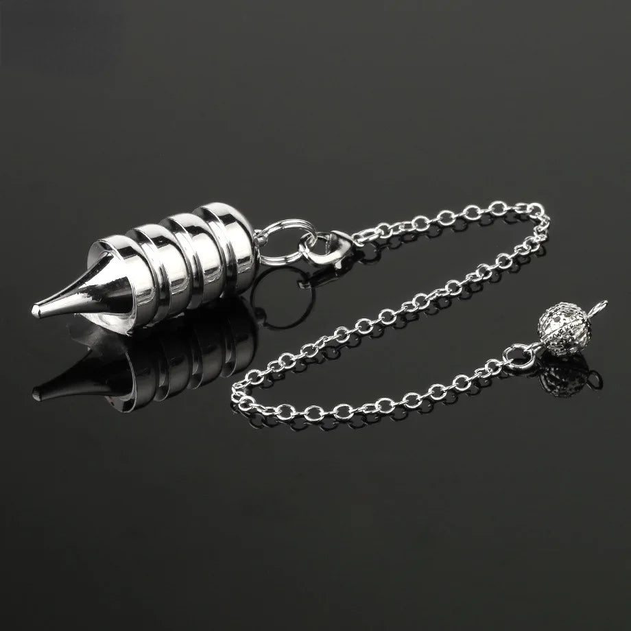 Silver metal pendulum on a chain against a black background