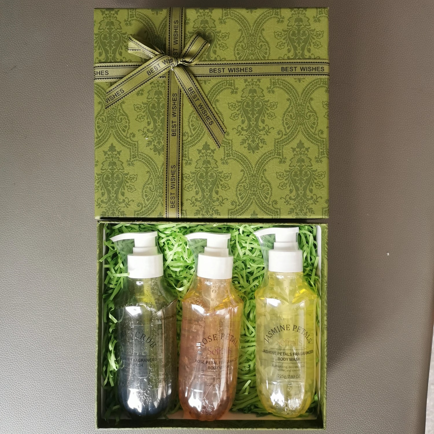 Three bottles of Jasmine & Bergamot skincare products in a decorative box with a green ribbon.