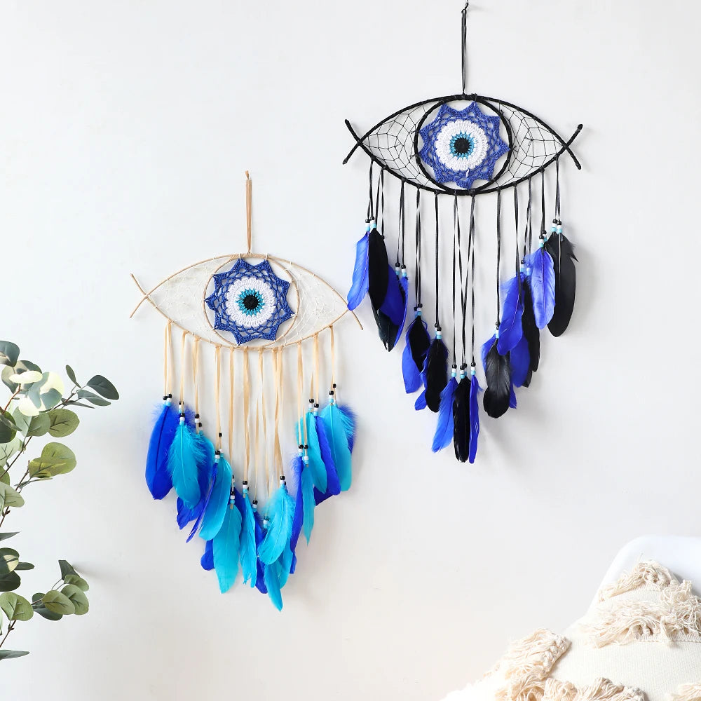Two dreamcatchers with blue and black feathers on a white background