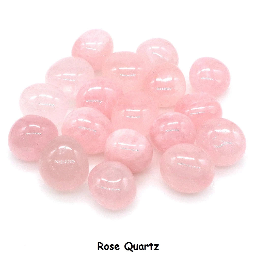 Pink rose quartz stones on a white background