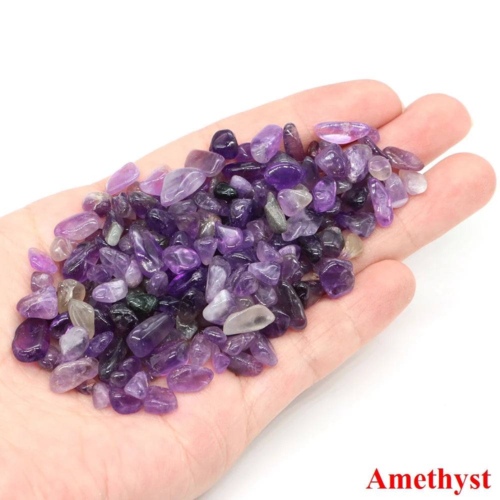 Hand holding a pile of amethyst crystals with 'Amethyst' text on a white background