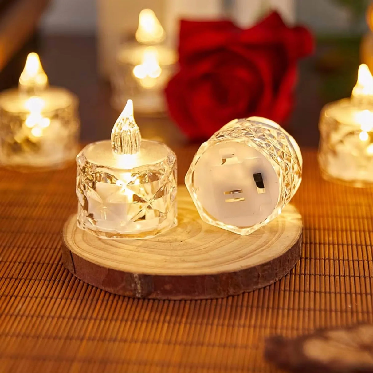 Decorative LED candles on a wooden base with a blurred background