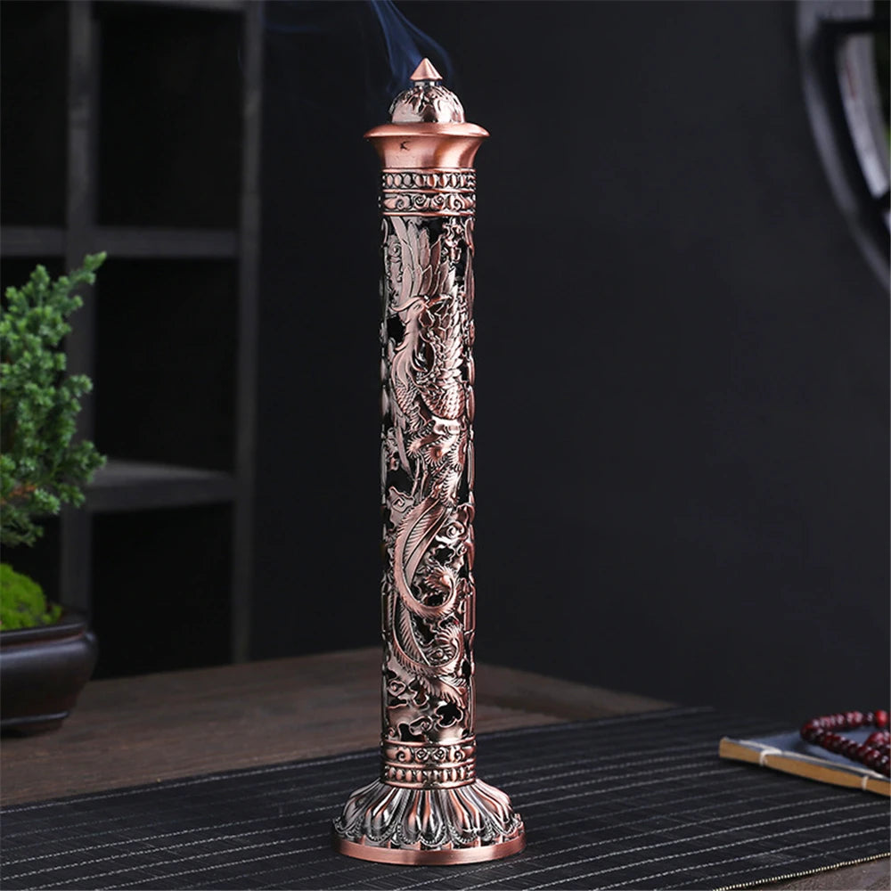 Decorative incense burner with intricate designs on a dark surface.