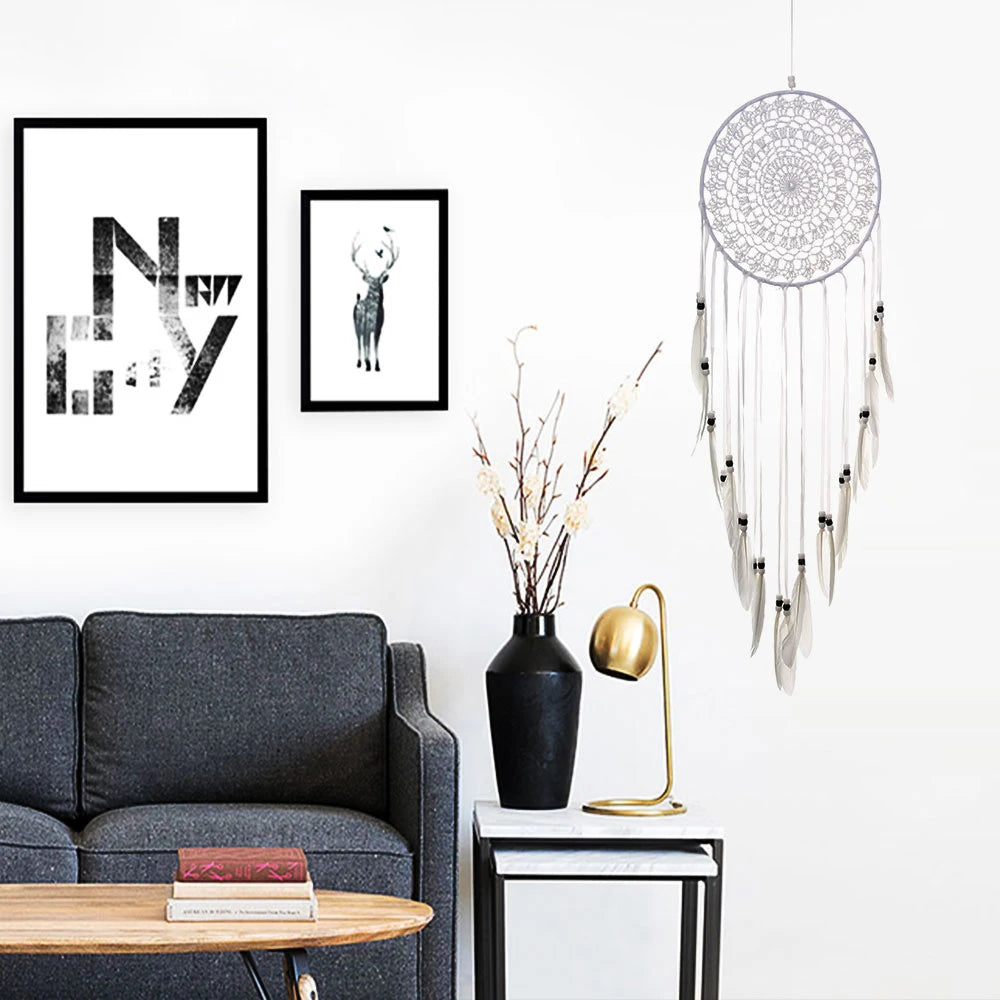Living room with gray sofa, framed art, and decorative items including a dreamcatcher.