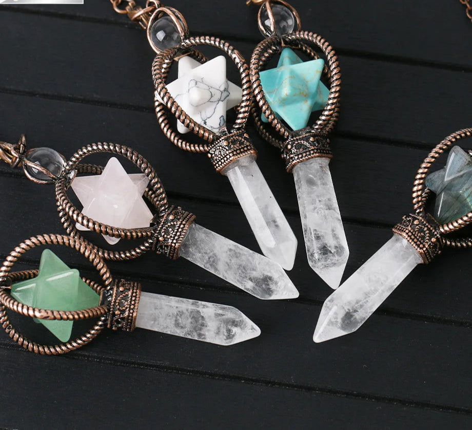 Crystal necklaces with star-shaped stones on a dark wooden surface, featuring the brand 'Cala Jewelry'.
