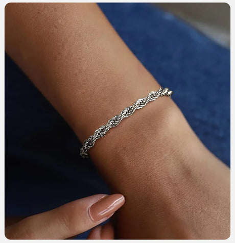 Silver bracelet on a wrist with a blurred background