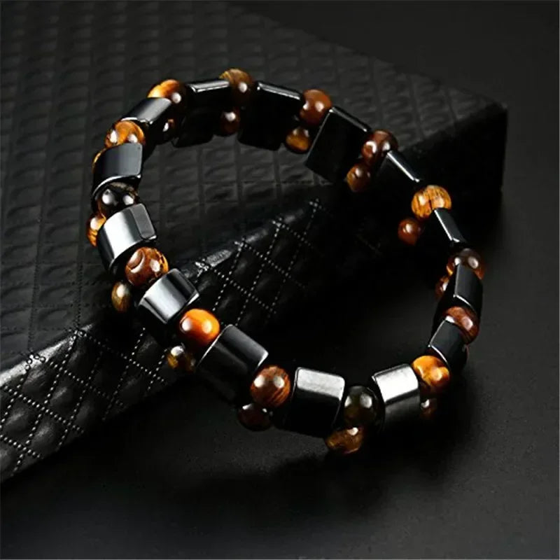 Black and brown beaded bracelet on a textured black surface