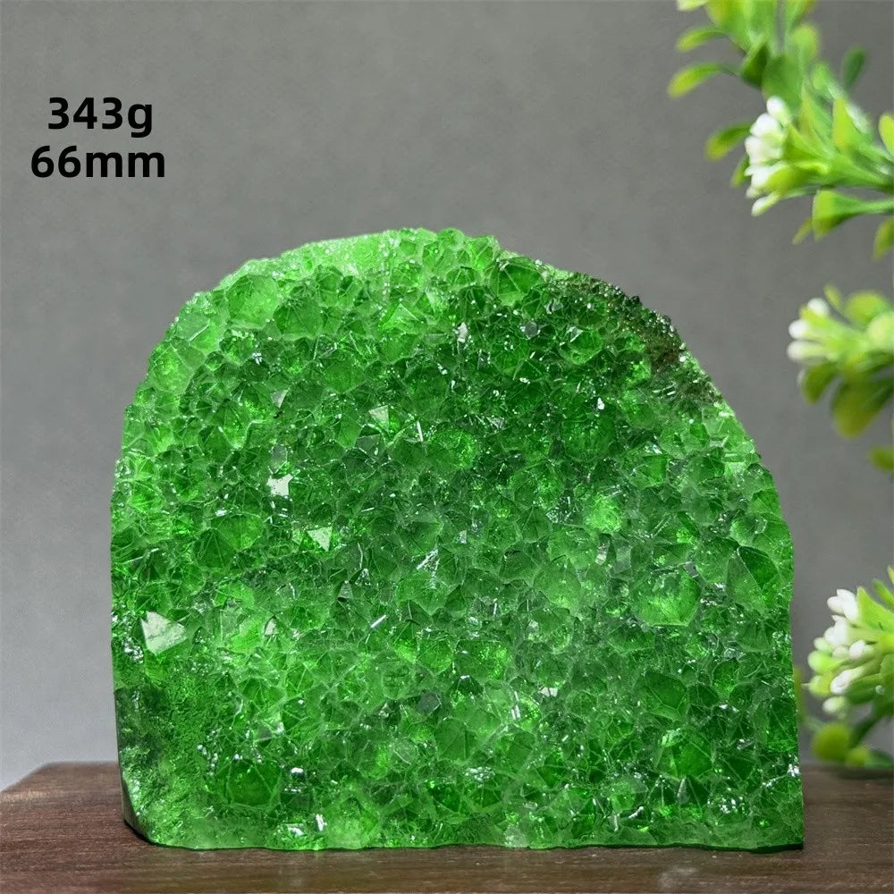 Green crystal rock on a wooden surface with a gray background