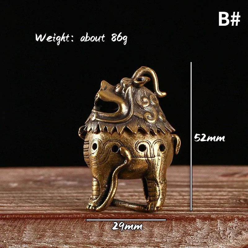 Bronze elephant-shaped object with measurements and weight on a wooden surface