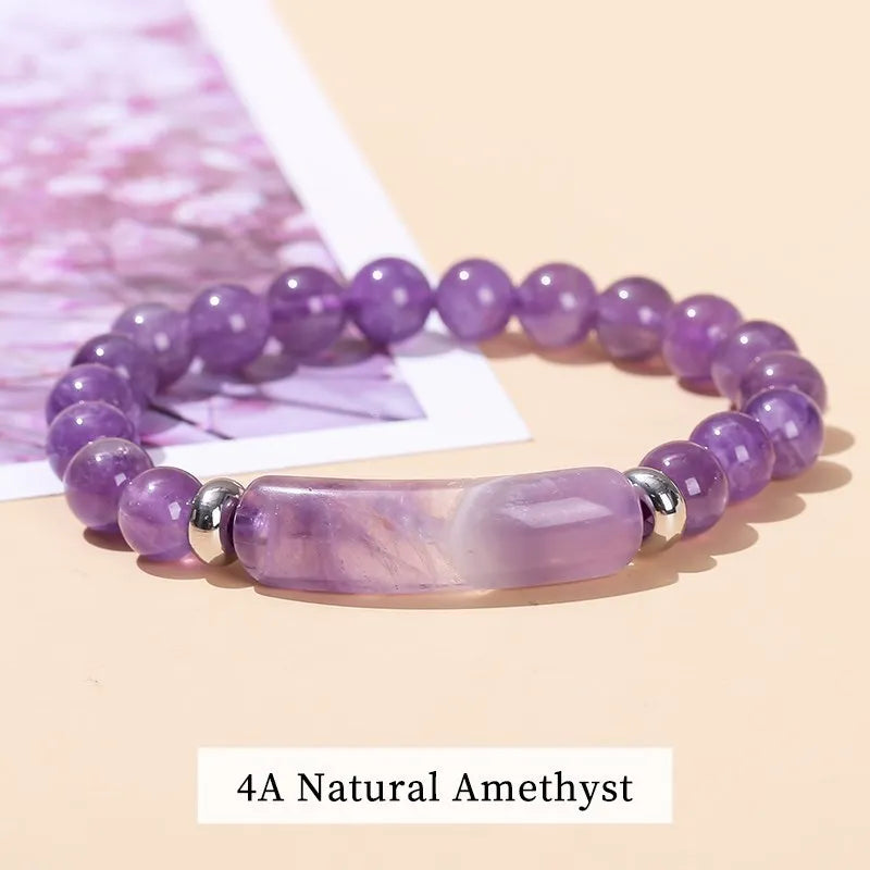 Purple amethyst bracelet with silver accents on a light pink background