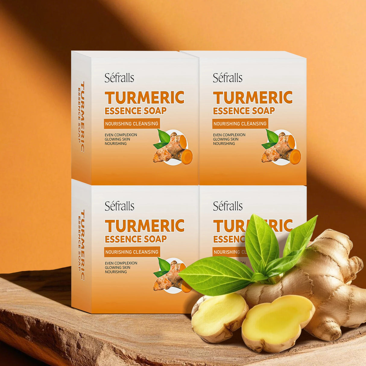 Three boxes of Séfralls Turmeric Essence Soap on a wooden surface with turmeric roots and leaves.