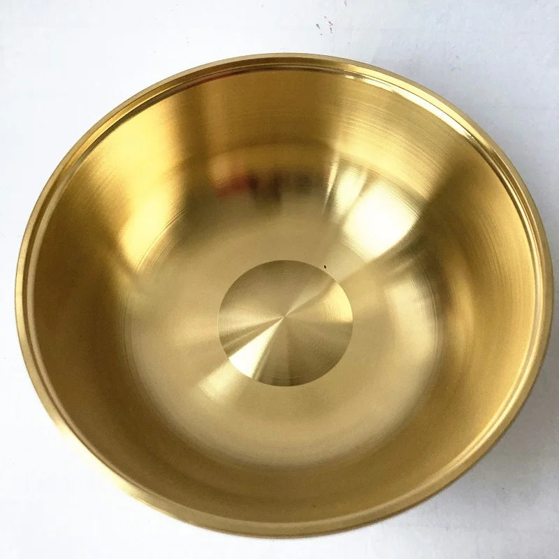 Gold metal bowl on a white background