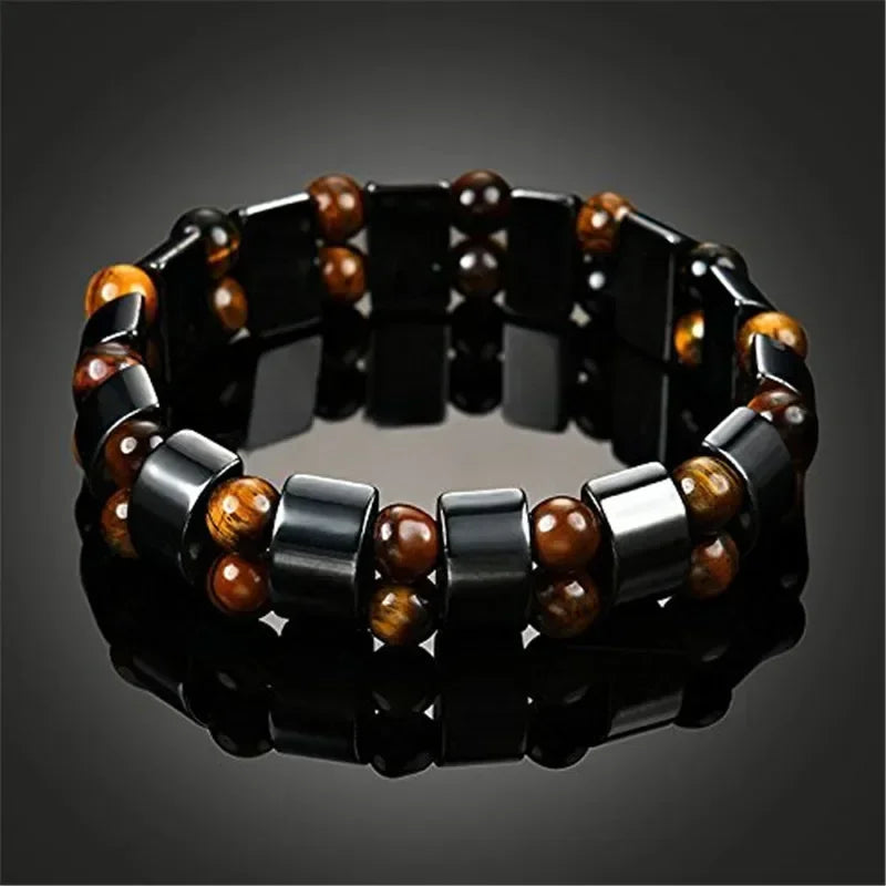 Bracelet with black, silver, and brown beads on a dark background
