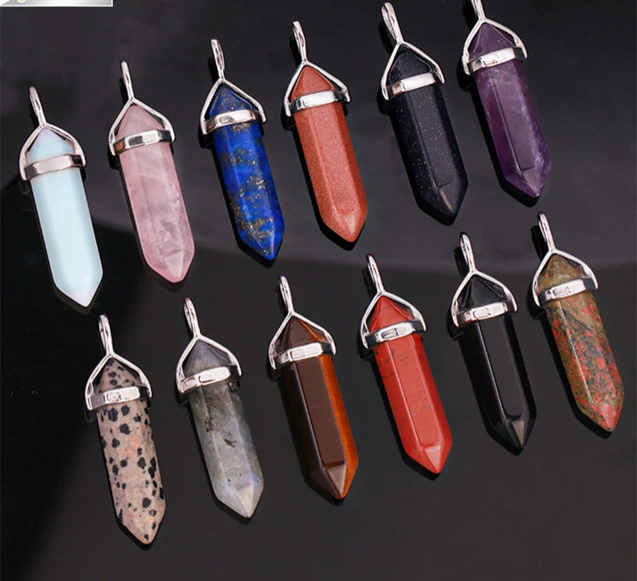 Collection of crystal pendants in various colors on a dark background