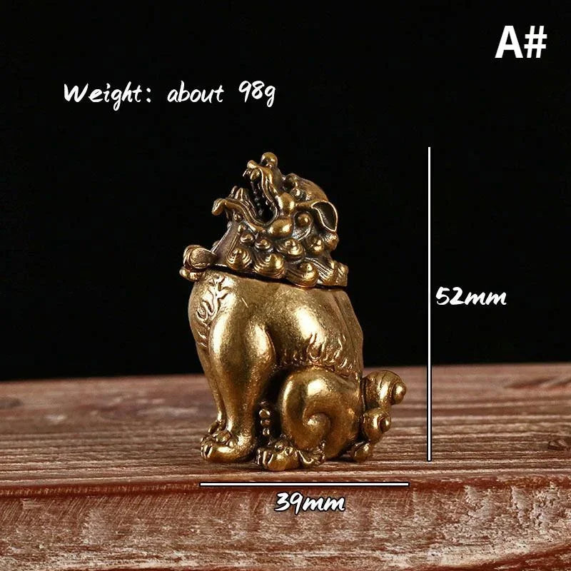 Gold lion statue with measurements on a wooden surface