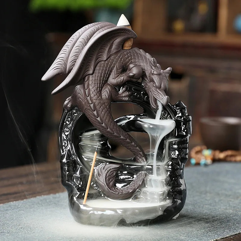 Dragon-shaped incense burner emitting smoke on a table