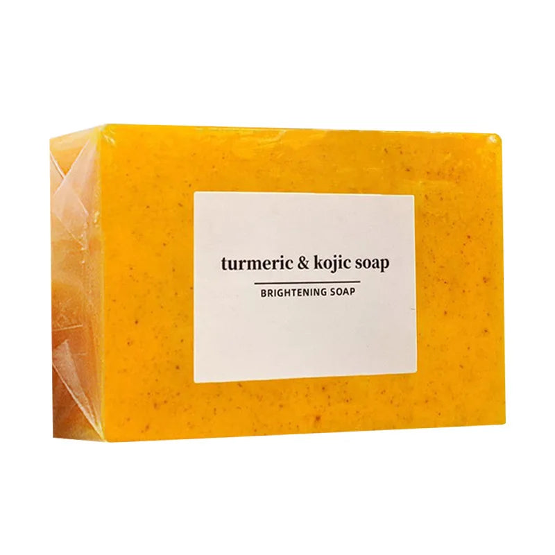 Yellow bar of turmeric & kojic soap with a white label on a white background