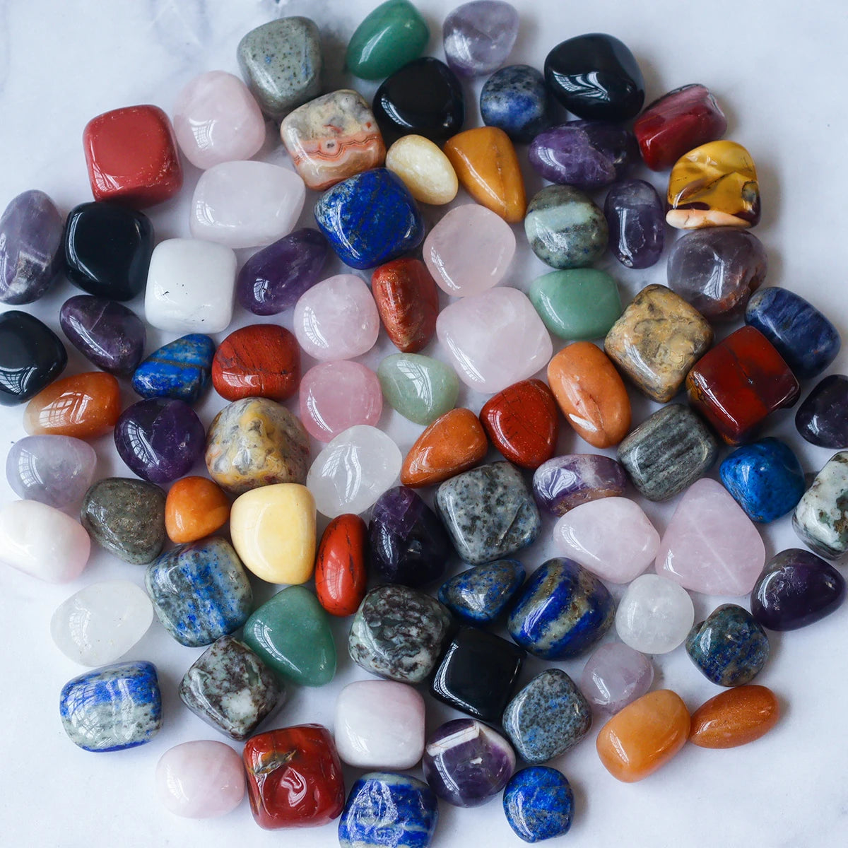 Assorted colorful gemstones on a white background
