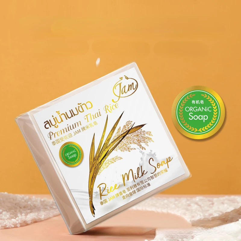 Box of Jam Premium Thai Rice Organic Soap on a beige surface with a yellow background