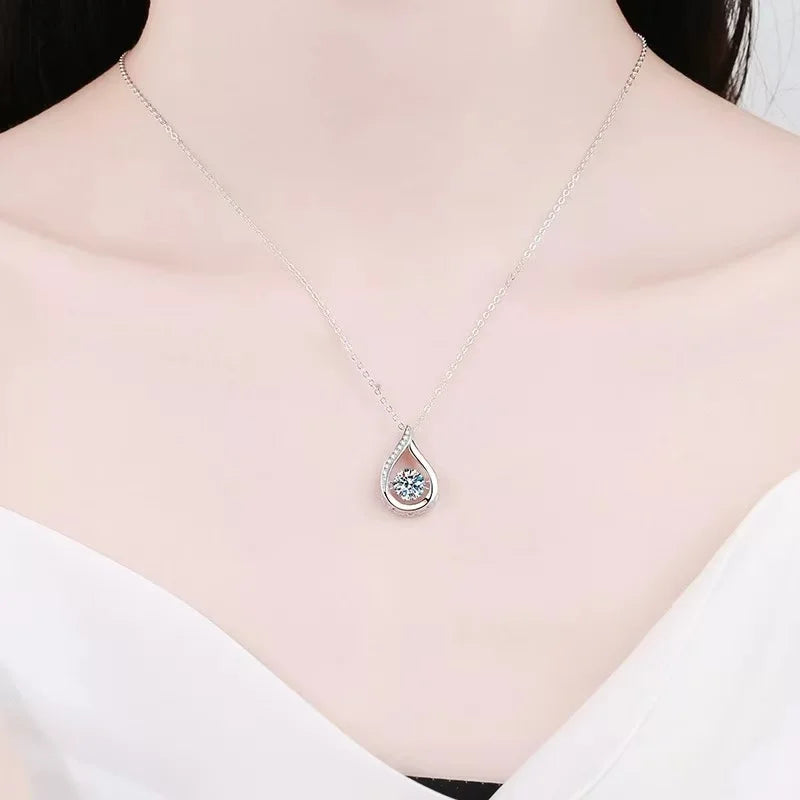 Silver teardrop necklace on a mannequin with a white top