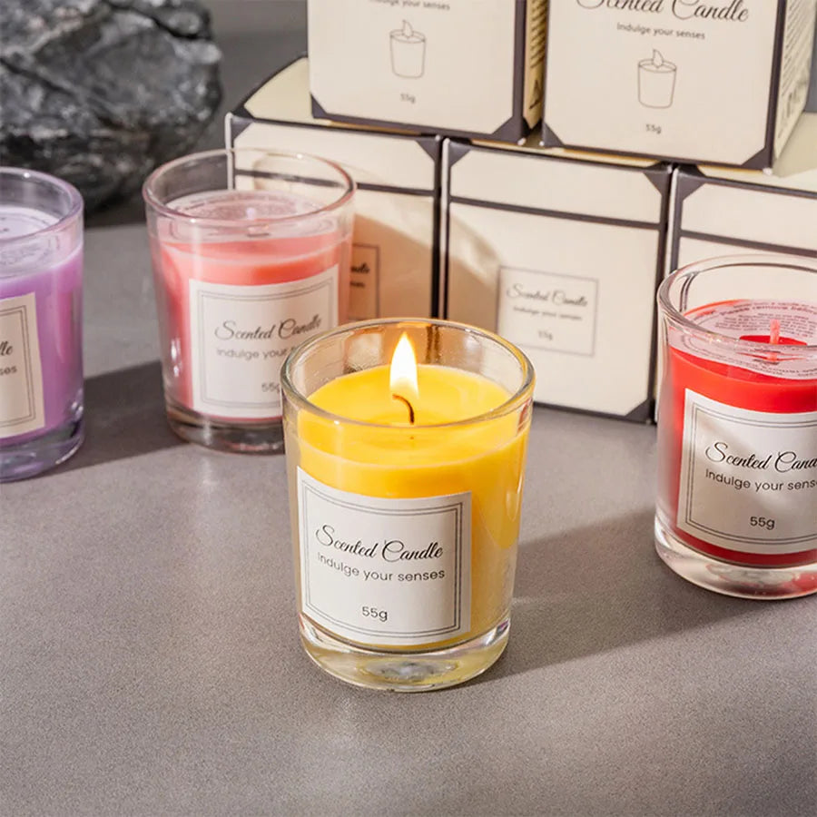 Set of scented candles with labels on a gray surface