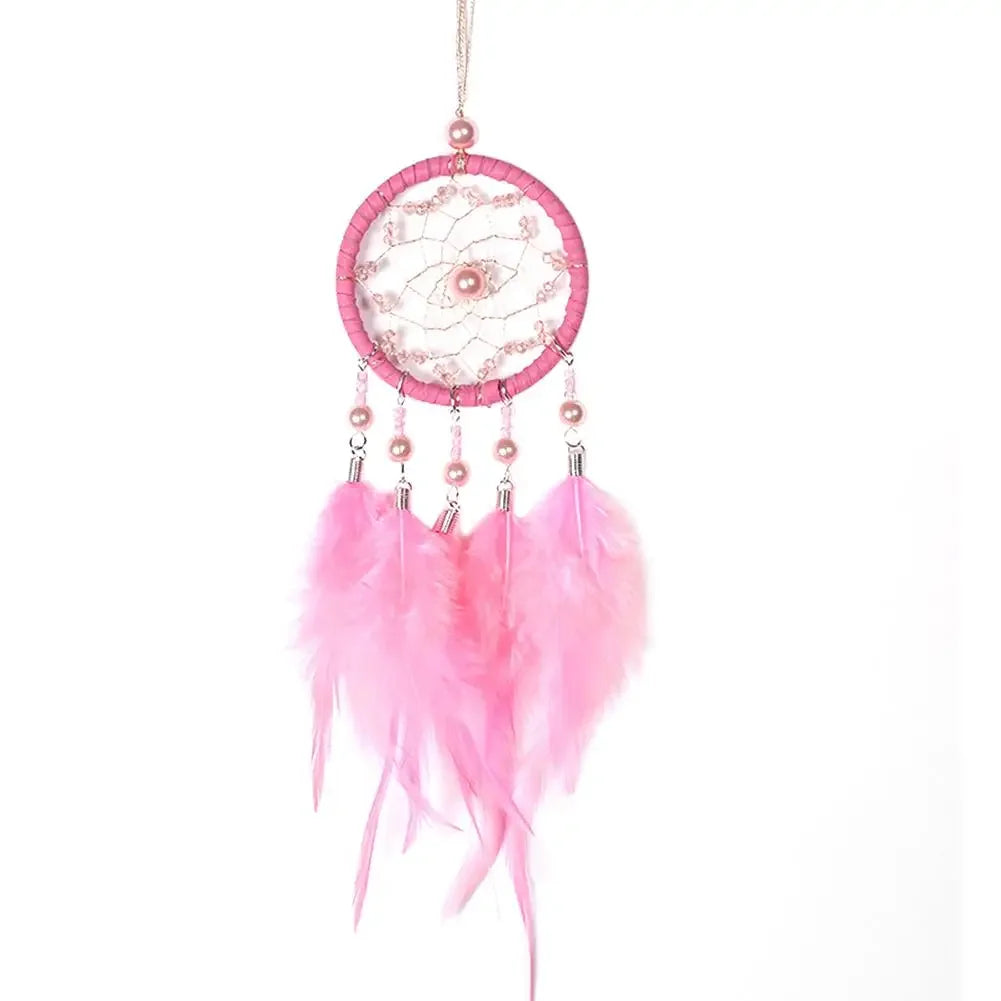 Pink dreamcatcher with feathers on a white background