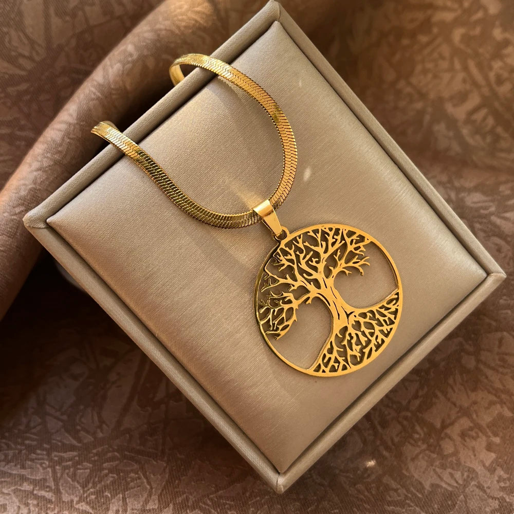 Gold tree-shaped pendant on a beige box with a brown textured background